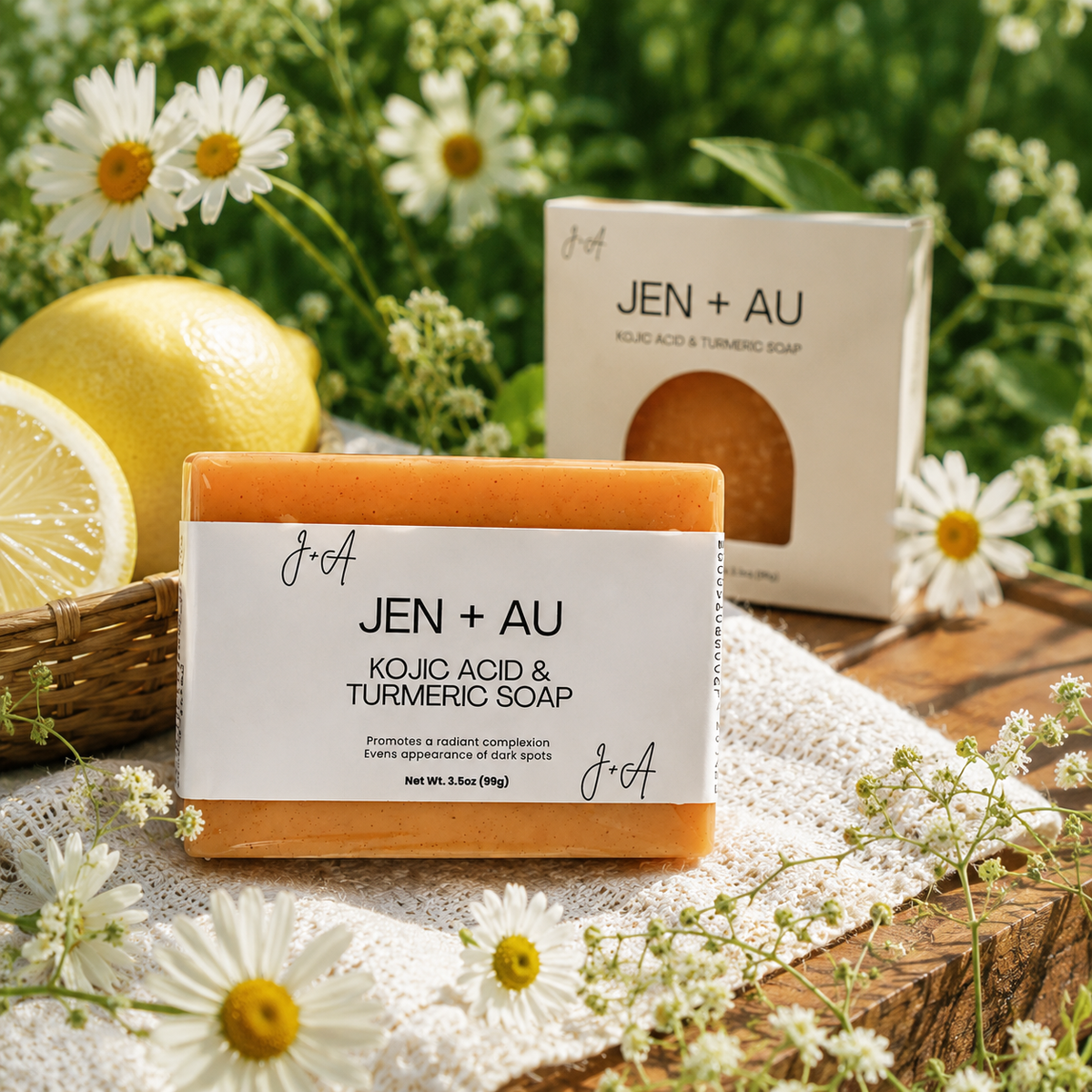 JEN + AU soap bar with packaging on a wooden surface with lemons and flowers